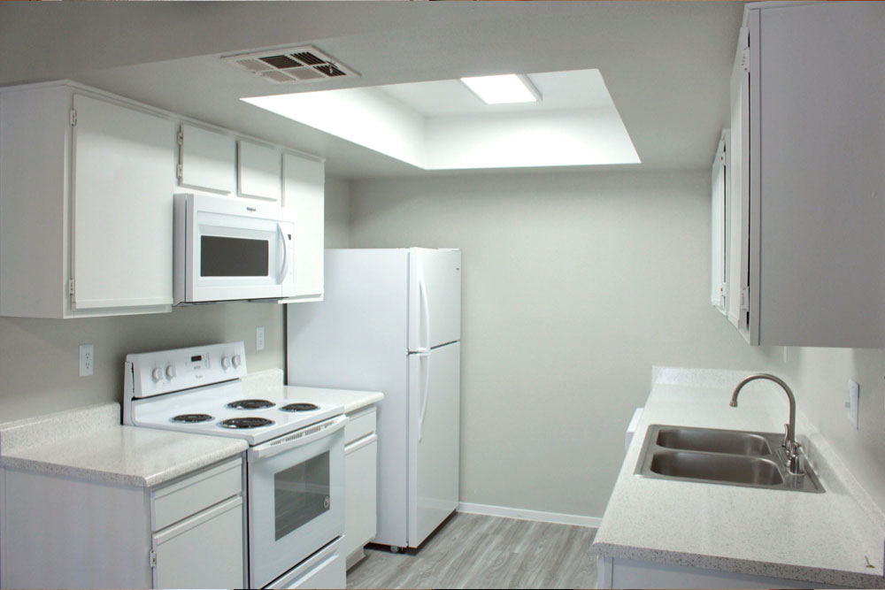 Modern kitchen with white cabinets and built-in appliances